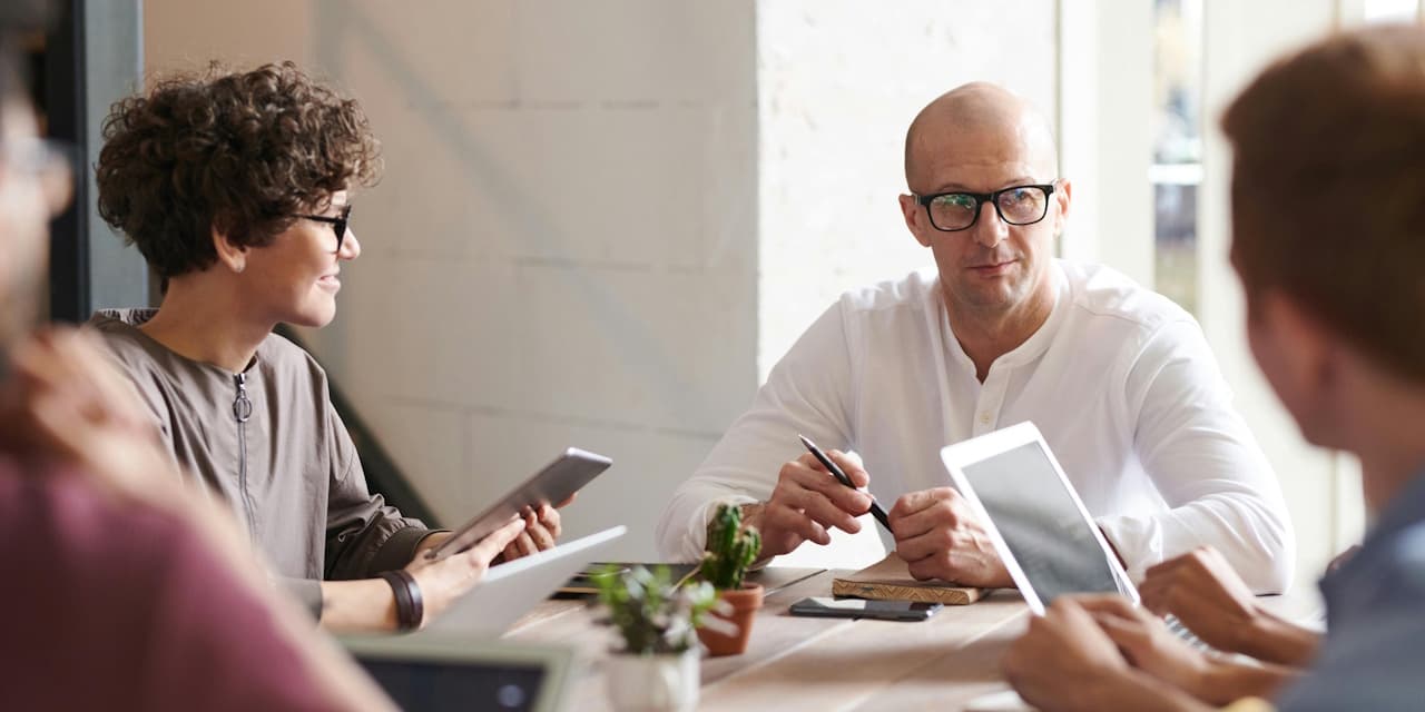 Business executives discussing fractional vs interim CIO strategies